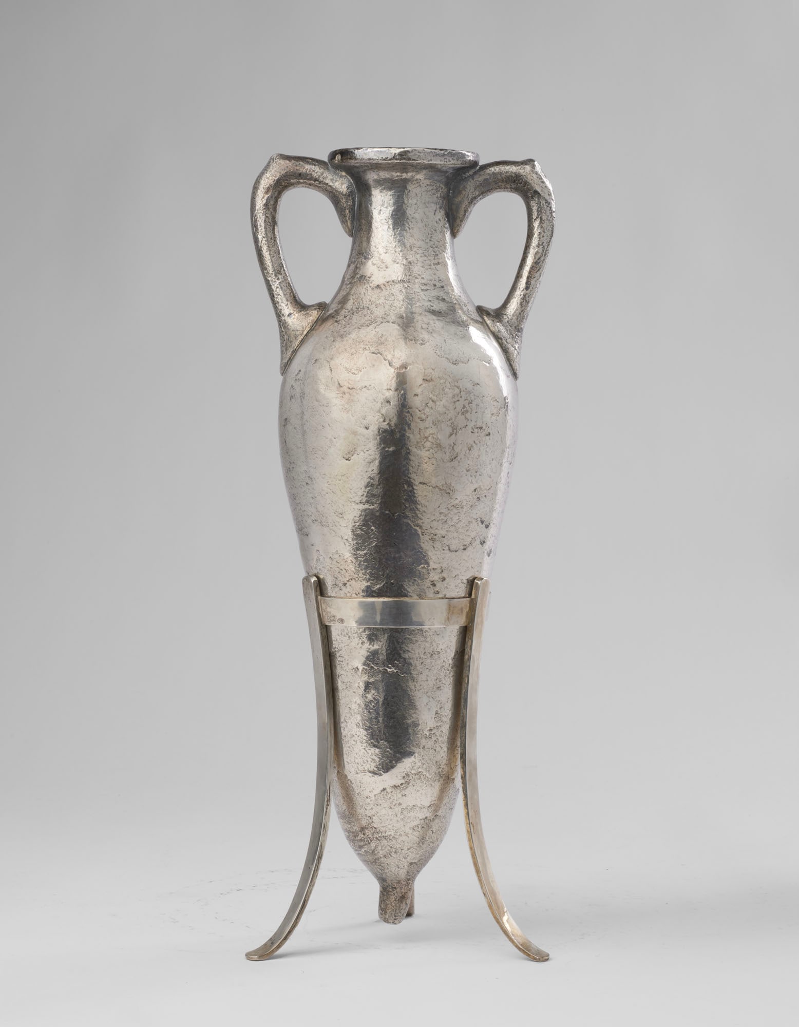 Giuseppe Villa Amphora in silver cast with an irregular surface to imitate excavated amphorae,: Giuseppe Villa Amphora in silver cast with an irregular surface to imitate excavated amphorae, supported by a tripod stand, title 800. Milan, 1960s/1970s. Marked on the tripod. (h cm 39. g 1300) Prove