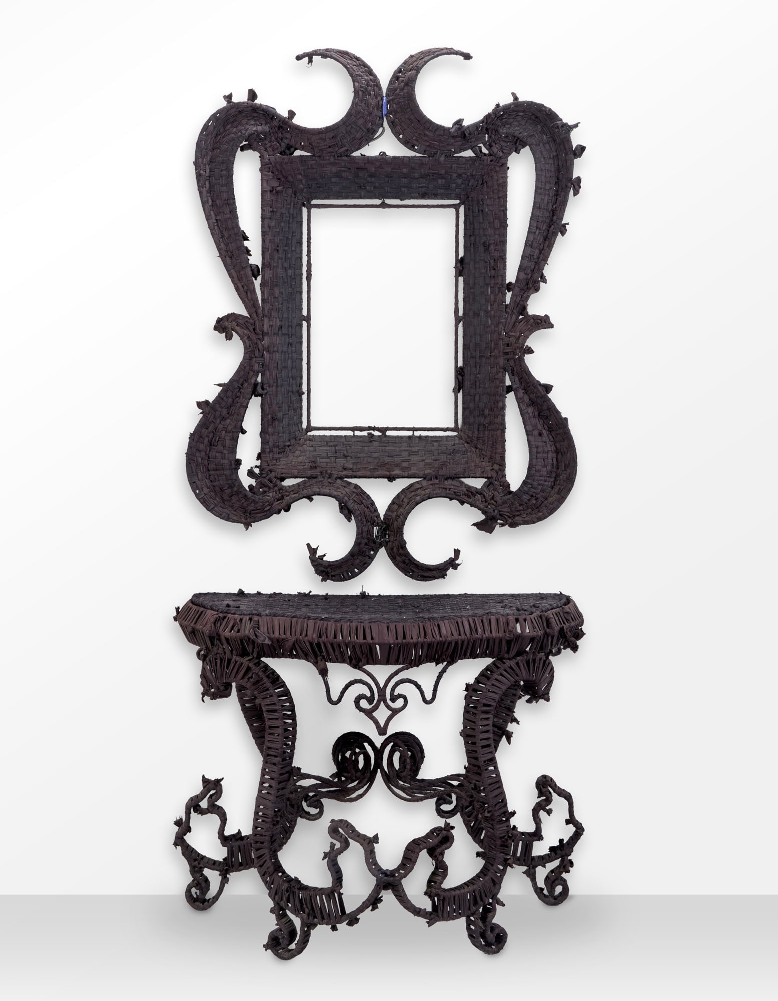 Anacleto Spazzapan (Luino 1943) Console with frame of the series "Stoffa". Italy, 2000s. Metal rod: Anacleto Spazzapan (Luino 1943) Console with frame of the series "Stoffa". Italy, 2000s. Metal rod frame, covered with hand-woven black fabric tape. (console cm 110x84x52; frame cm 145x100) IT Console