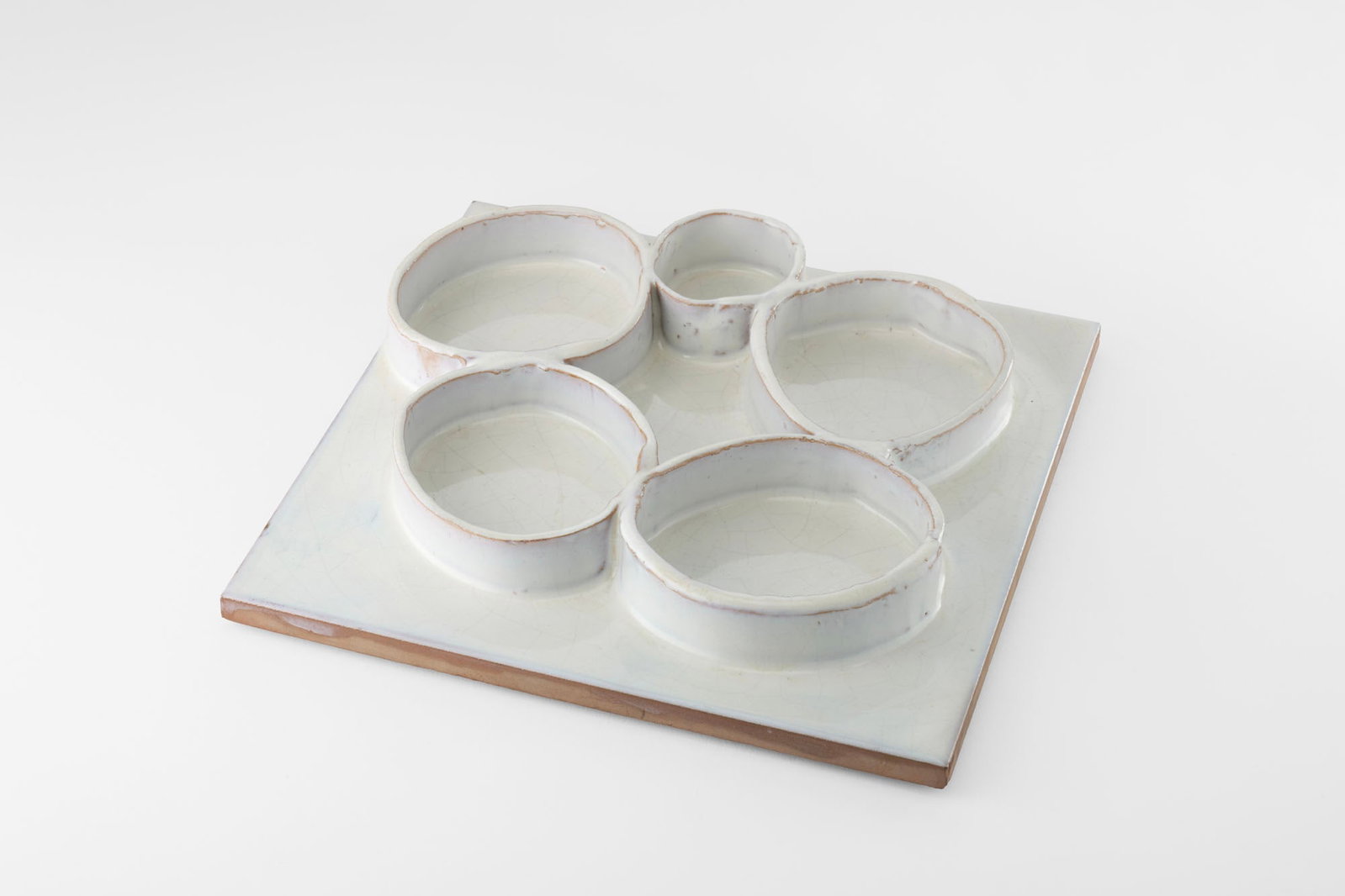 Fausto Melotti (Rovereto 1901 - Milano 1986) Tile. 1955ca. White glazed ceramic, decorated with five (1 of 3)