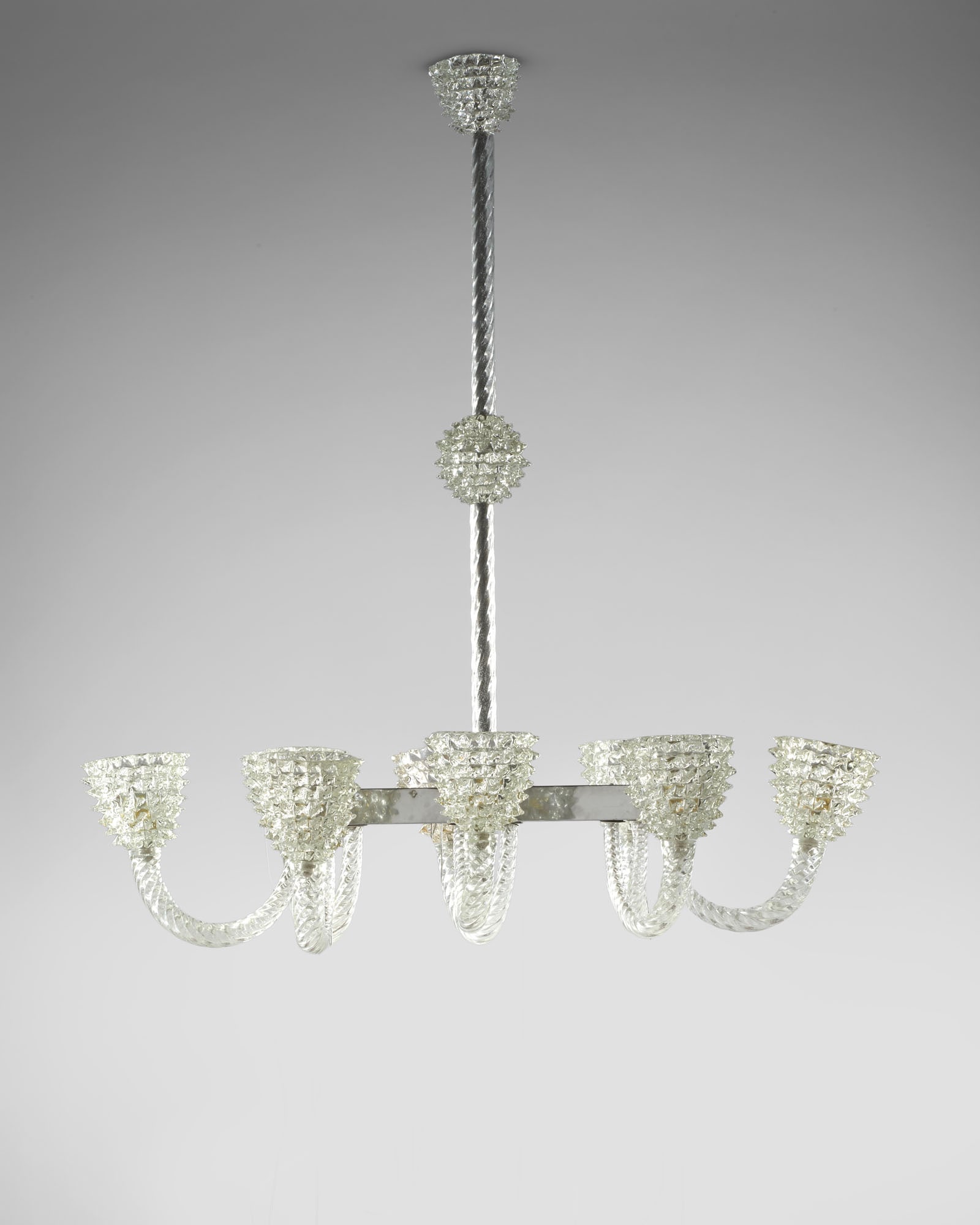 Ercole Barovier (Murano 1889 - Venezia 1974) Eight-light chandelier. Manufacture of Barovier e Toso,: Ercole Barovier (Murano 1889 - Venezia 1974) Eight-light chandelier. Manufacture of Barovier e Toso, Murano, 1930s/1940s. Beaked crystal glass, nickel-plated brass frame. (65x115 cm.) IT Lampadario a 