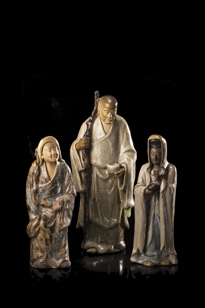 Three glazed ceramic figures, each wearing long robes: Three glazed ceramic figures, each wearing long robes in green and grey tones (minor losses) China, 20th century (the largest h. 24 cm.)