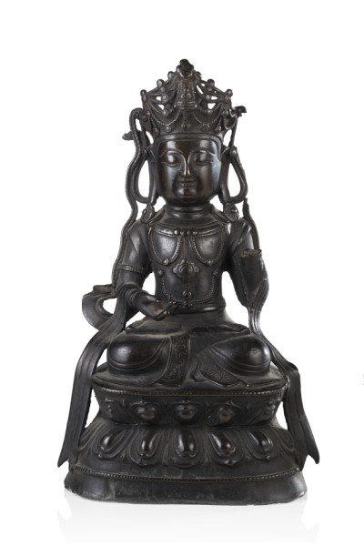 A bronze model of a Bodhisattva seated on a: A bronze model of a Bodhisattva seated on a double-lotus base, wearing an elaborate crown and beaded jewelry (losses and flaws) China, Ming dynasty (1368-1644) (h. cm. 23)