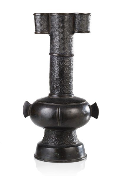 A bronze bottle vase with tubular handles, the neck: A bronze bottle vase with tubular handles, the neck decorated with geometric motifs China, Ming dynasty (1368-1644) (h. cm. 21,5)