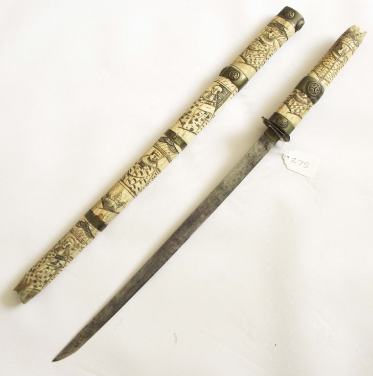 JAPANESE BONE AND BRASS MOUNTED SHORT SWORD: JAPANESE BONE AND BRASS MOUNTED SHORT SWORD Sword of 16 inches in a carved and polychromed bone scabbard, decorated with brass fittings.