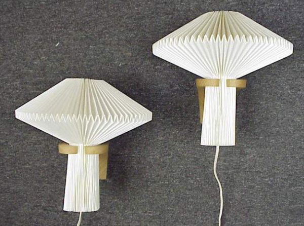 Pair of Le Klint wall sconces, pleated plastic s: Pair of Le Klint wall sconces, pleated plastic shades and teak, 10"h, marked on back