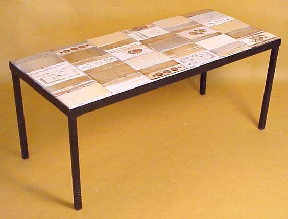 Roger Capron/ France cocktail table, hand made: Roger Capron/ France cocktail table, hand made tiles with impressed leaves & geometric shapes, painted iron base, signed in tile, 15 1/2"h x 36" x 16" (minor loss to grout)
