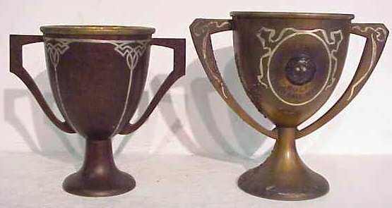 2 Heintz sterling on bronze trophy cups: 7 1/4"