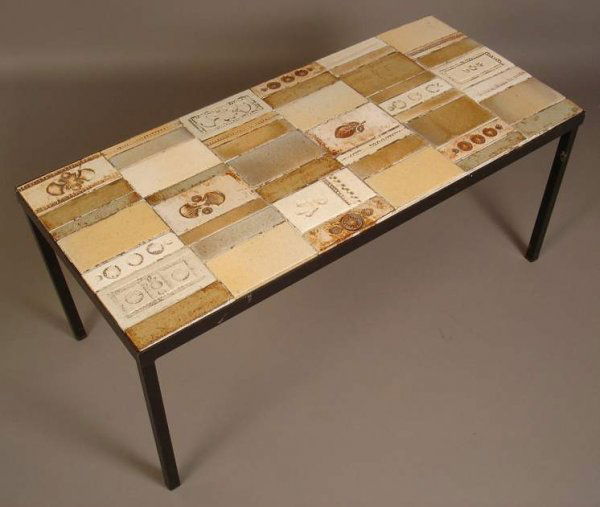 Roger Capron/ France cocktail table, hand made ti: Roger Capron/ France cocktail table, hand made tiles with impressed leaves & geometric shapes, painted iron base, signed in tile, 15 1/2"h x 36" x 16" (minor loss to grout)