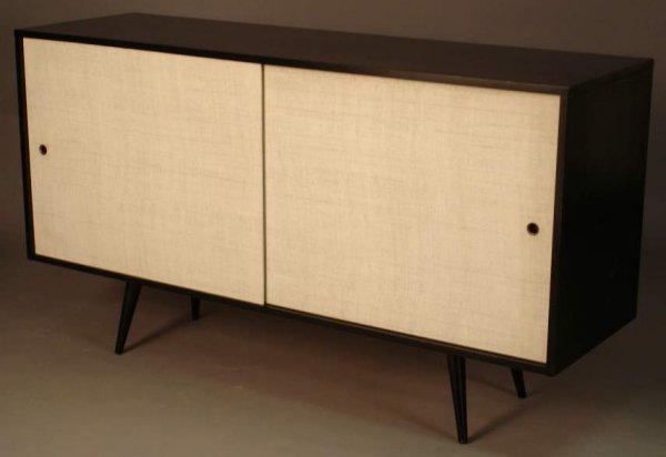 Paul McCobb / Winchendon Planner Group credenza,: Paul McCobb / Winchendon Planner Group credenza, two linen covered sliding doors conceal a adj. shelf & four pullout drawers.Marked in the drawer ,black enamel finish.33 1/4"h x 60"w x 18".( overall g