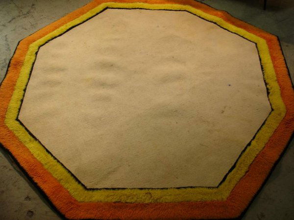 Edward Fields wool carpet, octagon shape with ivo: Edward Fields wool carpet, octagon shape with ivory field,black,yellow,& orange border.Marked;Edward Fields Inc.,copyright,1966.Measures 104" x 104". Cond. some stains in the field.