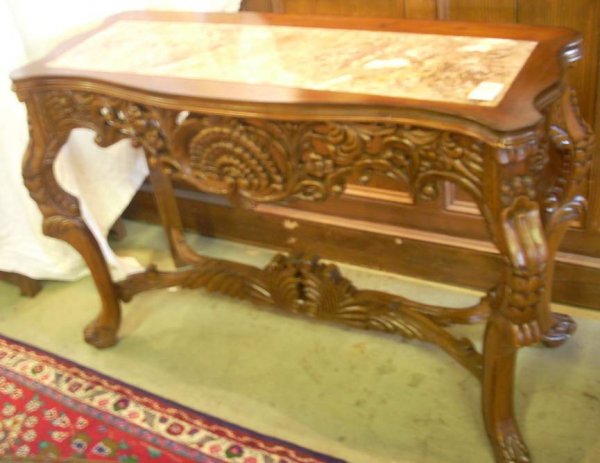 Ornately carved walnut console table with carved