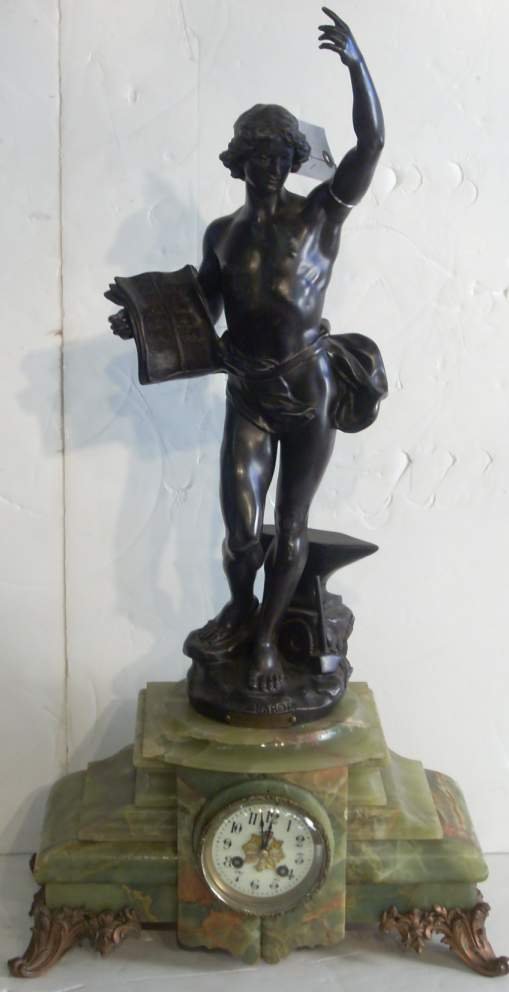 "Industry", white metal figural clock mounted on