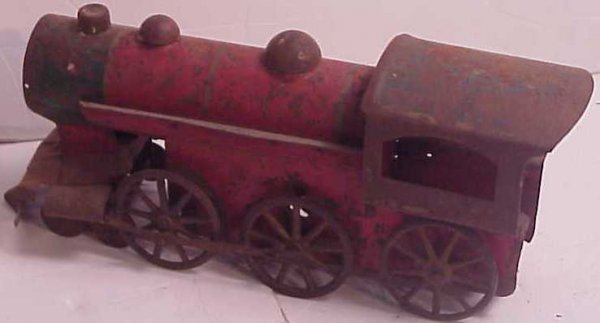 Tin toy train engine, painted, as found, has rust