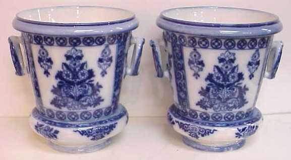 PAIR EARLY BLUE AND WHITE PORCELAIN PLANTERS WITH: PAIR EARLY BLUE AND WHITE PORCELAIN PLANTERS WITH UNDERPLATES, MARKED ON BASE "P. REGOUT & CO MAASTRICHT", ONE UNDER PLATE HAS BEEN REPAIRED.