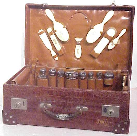 Alligator suitcase fitted with 8 sterling glass to