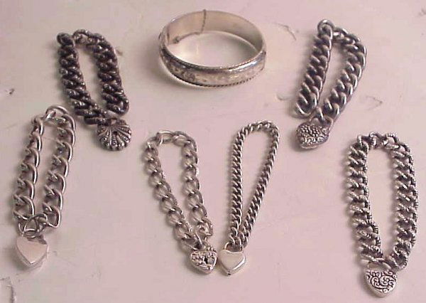 Lot of sterling silver bracelets includes 3 Vict: Lot of sterling silver bracelets includes 3 Victorian chased hollow link bracelets with chased heart charms (keys missing), 3 other bracelets with heart charms and an engraved hinged bangle bracelet