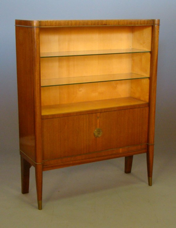 De Coene Studios / Belgium display cabinet, circa: De Coene Studios / Belgium display cabinet, circa 1940. Mahogany with sycamore interior,lac. brass detail,sabots & placquard.Top portion has two glass ,below has dropfront door which conceals open sto