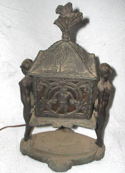 Figural Nude spelter lamp Manner of Frankart, 14": Figural Nude spelter lamp Manner of Frankart, 14" h replaced glass lenses, small piece of finial missing.