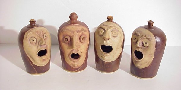 4 Alan Long stoneware faces, 8 1/2"