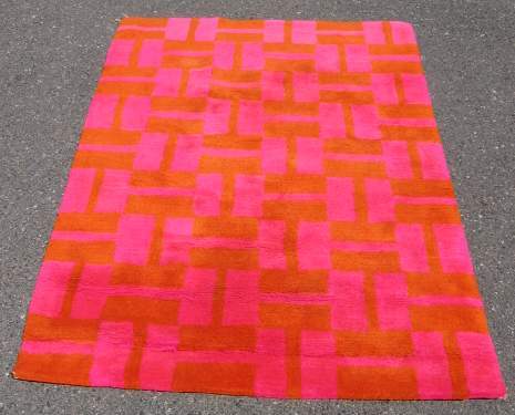 EDWARD FIELDS AREA RUG, 1963, WITH ORANGE AND PIN: EDWARD FIELDS AREA RUG, 1963, WITH ORANGE AND PINK FIELD, RETAINS LABEL VERSO, 71" X 47"