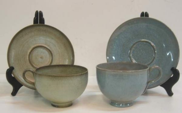 EDWIN & MARY SCHEIER TWO LARGE CUP & SAUCER'S.THE: EDWIN & MARY SCHEIER TWO LARGE CUP & SAUCER'S.THE BLUE CUP WAS MADE BY EDWIN FOR BETTY AS A GIFT TO HER MOTHER.SIGNED B.F.-CEF 8-2-54;SCHEIER.BLACK BALL CLAY W/ BLUE SLIP.CUP WAS REPAIRED BY A RESTORE