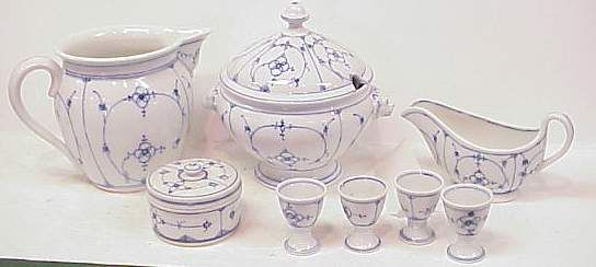 8 PC EARLY GERMAN PORCELAIN SERVING PIECES: PITCH: 8 PC EARLY GERMAN PORCELAIN SERVING PIECES: PITCHER (6 1/4"H), GRAVY BOAT (4"H X 7 1/2"L), COVERED TUREEN (8"H), 4 EGG CUPS (2 1/4"H, ONE CRACKED) & LIDDED BOX (2 1/2" X 3 3/4")