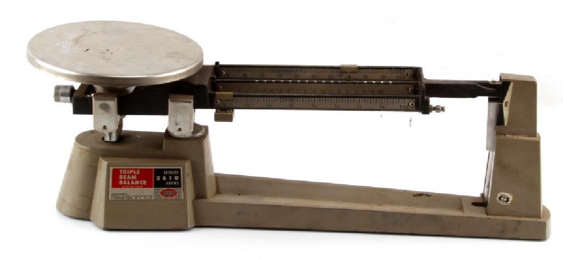 VINTAGE OHAUS BRAND TRIPLE BEAM BALANCE SCALE: Vintage Ohaus brand triple beam balance scale made by Ohaus Scale Corporation with a 2610 gram capacity and magnetic damping feature as pictured on sticker . This item measures by 15.5''by 4.5'' by 6'