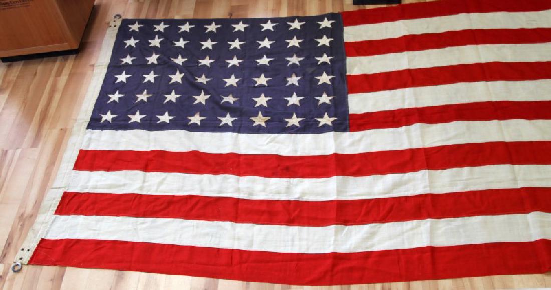 WWII VINTAGE 48 STAR FLAG UNITED STATES OF AMERICA: Measures 113" by 57". In good condition with wear due to age.