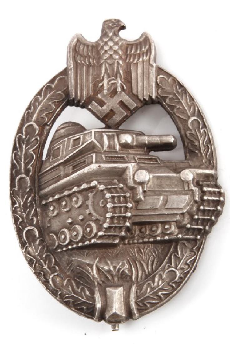 WWII PANZER TANK MARKED ASSAULT BADGE IN SILVER: WWII German Third Reich Panzer Tank Assault badge in silver. Measuring 2.5''' long by 1.5''. With a maker's marking on the obverse of centered Swastika reading "AS" in a triangular logo. Item is in ov