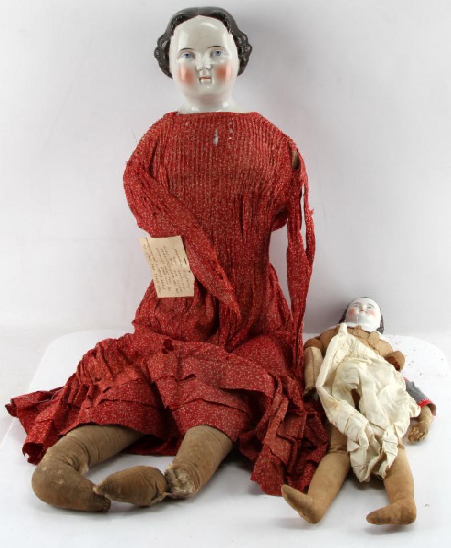 LOT OF 2 ANTIQUE CHINA HEAD DOLLS: LOT OF 2: 1) 36" antique china head doll. Doll has no arms, small tear to one leg and significant one to the another. Dress is worn and has some small tears. A few small spots of paint wear to back of