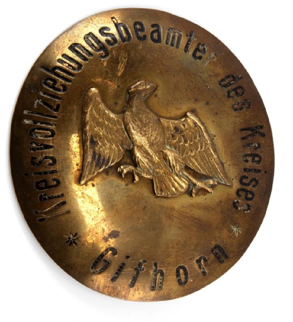 PRE WWI PRUSSIAN OFFICIAL RING BADGE: Pre-WWI Prussian official ring badge. Center has Frederick the Great Eagle of the Prussian Empire. Measures 3 and 1/2" tall and 3" wide. Fastening pin on the back as been soldered. Unauthenticated, so