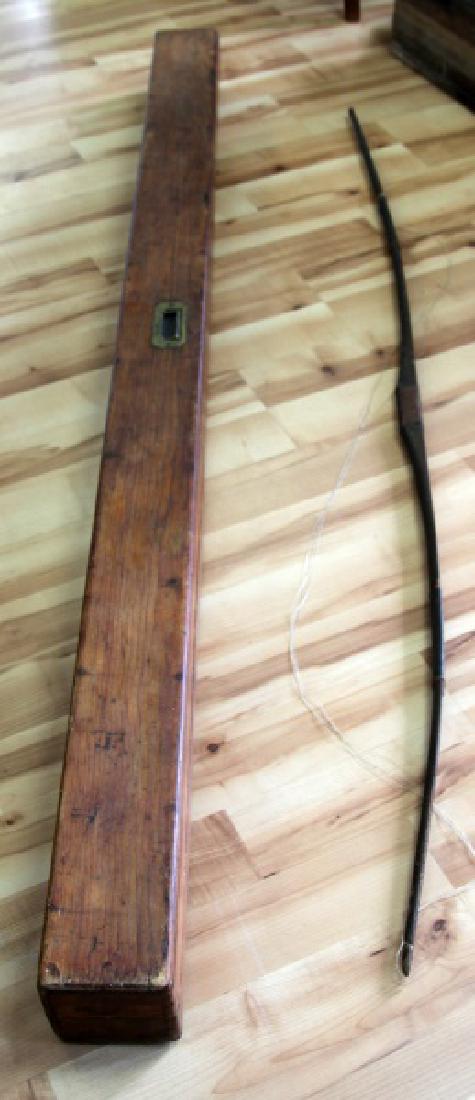VINTAGE WOODEN LONGBOW W LEATHER GRIP & WOOD CASE: 67" vintage wooden longbow with leather wrapped grips. Unsure if bowstring is original. Comes with 75 1/2" wooden bow & arrow case. Case interior has wooden locks and small compartment with lid. Brass