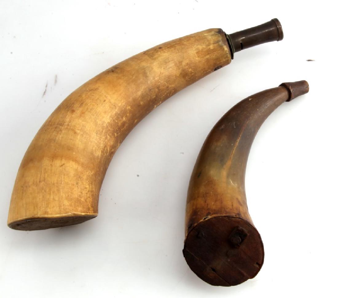 SET OF 2 ANTIQUE POWDER HORN FLASKS EARLY AMERICAN: Set of two antique powder horn flasks. Smaller one (7 3/4") has wooden spout and is worn/cracked towards base. Small strip of leather is attached to base, presumably where a strap had been connected a