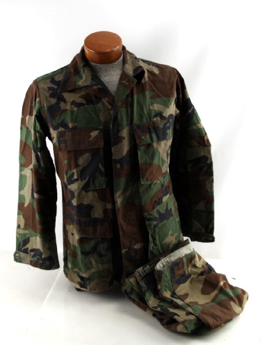 VINTAGE WOODLAND PATTERN CAMOFLAGE OUTFIT: Vintage woodland pattern camoflage combat outfit. Jacket - inside product labels well worn and difficult to decipher. One label is signed, but hard to read. Approximate measurements: 18" (shoulders), 