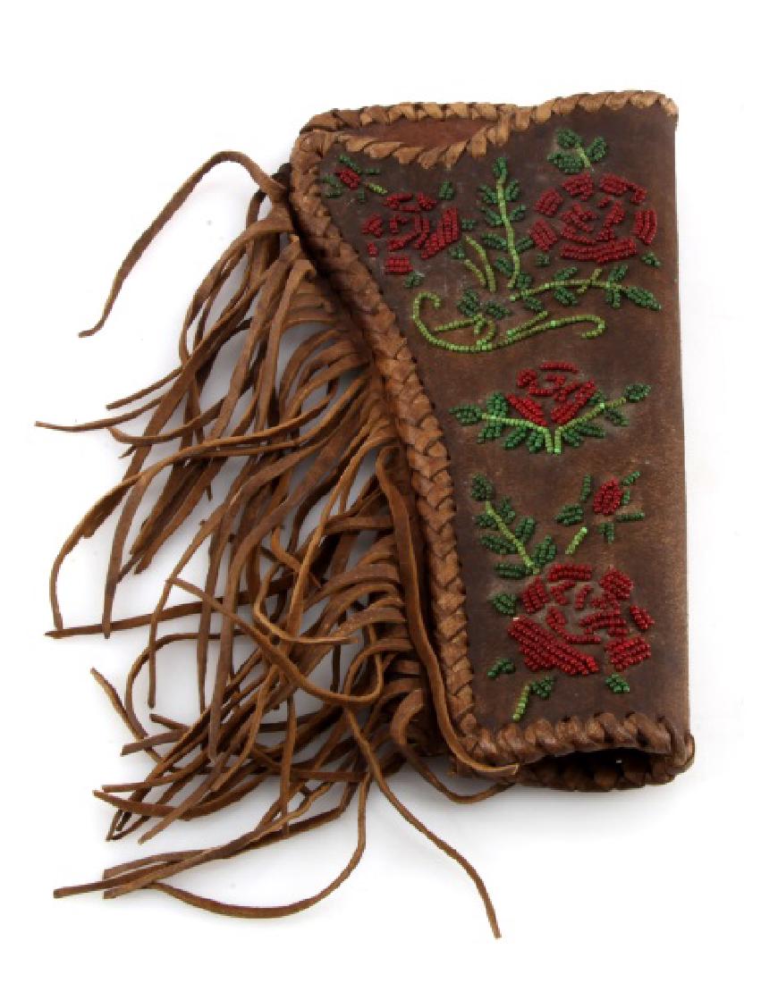 VINTAGE PAWNEE BILL'S BEADED WESTERN HOLDER COLT: This beaded western holster from Pawnee Bill's wild west show fits a standard 44 or 45 caliber single action Colt revolver. All beads and tassels intact. Some wear to back of holster. Good condition.