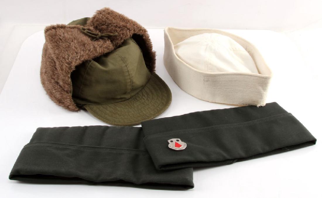 WWII AND POST WAR US MILITARY UNIFORM HEADWEAR: Four articles of US military headwear in use from WWII through Vietnam. Items include a Korean War era US Army field pile cap (Model 1951); 2 US Army Men's Garrison Caps, one with the insignia badge o