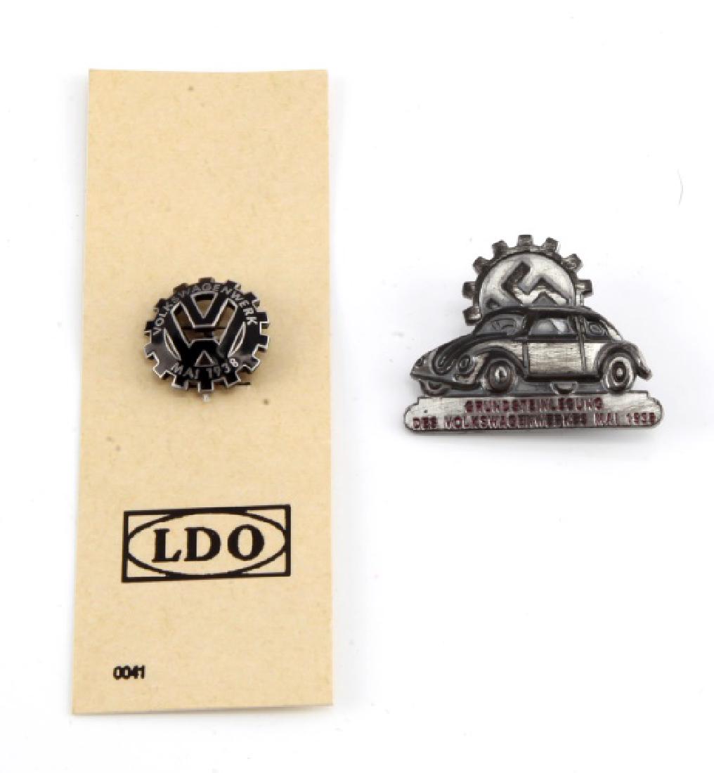 LOT OF 2 - 1938 VOLKSWAGENWERK COMMEMORATIVE PINS: Lot of 2: 1) Volkswagen commemorative pin of VW Beetle with rising Swastika gear behind it. Marked "GRUNDSTEINLEGUNG DES VOLKSWAGENWERKES MAI 1938." Measures approximately 1 1/2" by 1 1/4". 2) "VOLKSW