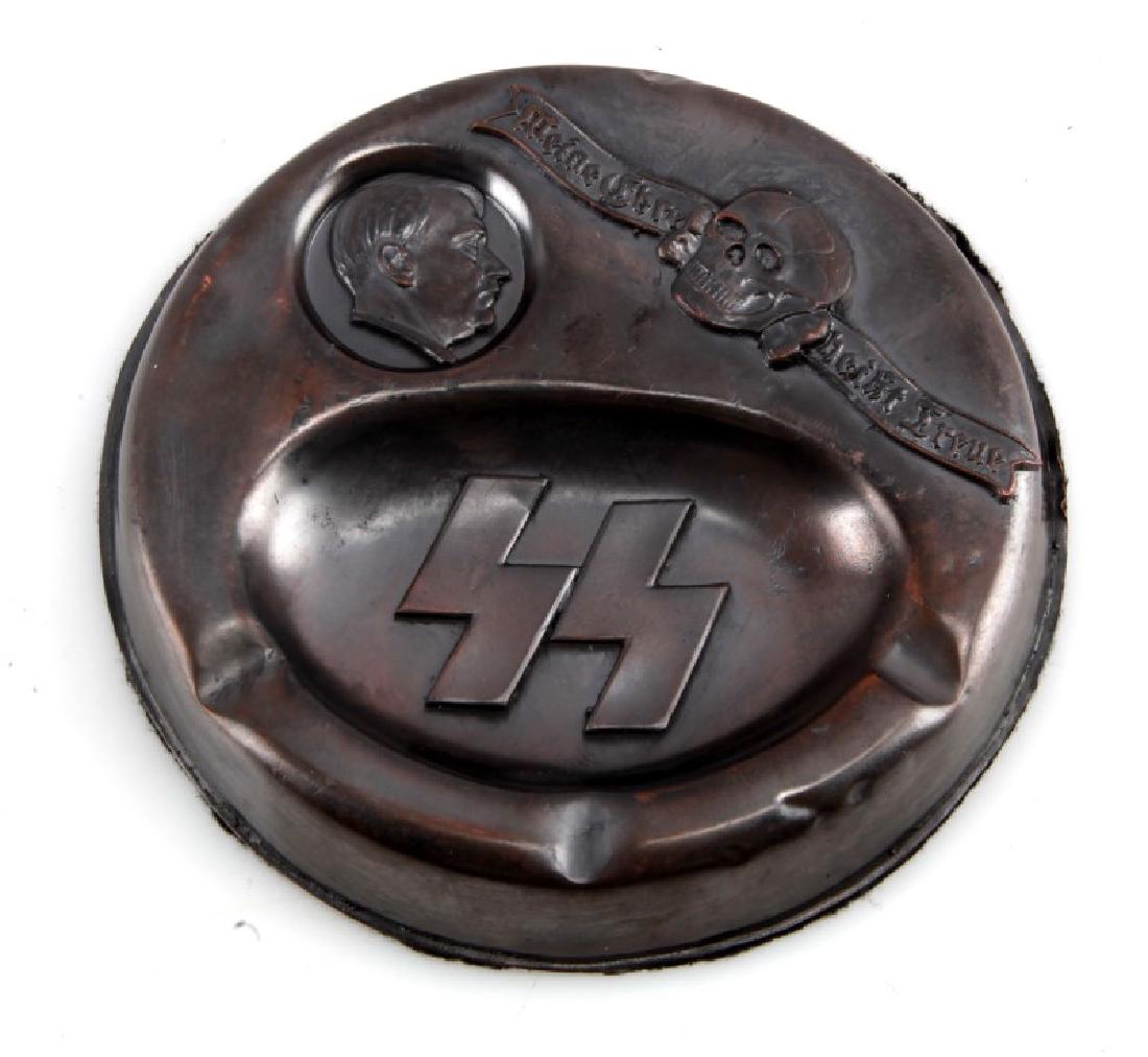 WAFFEN SS ADOLF HITLER ASHTRAY GERMAN WWII: 5 1/4" tin (?) German Third Reich period Waffen SS Adolf Hitler Ashtray. A few small dents and normal wear. Felt bottom with two tiny spots of wear. Unauthenticated. Sold "as is". This lot has a reser