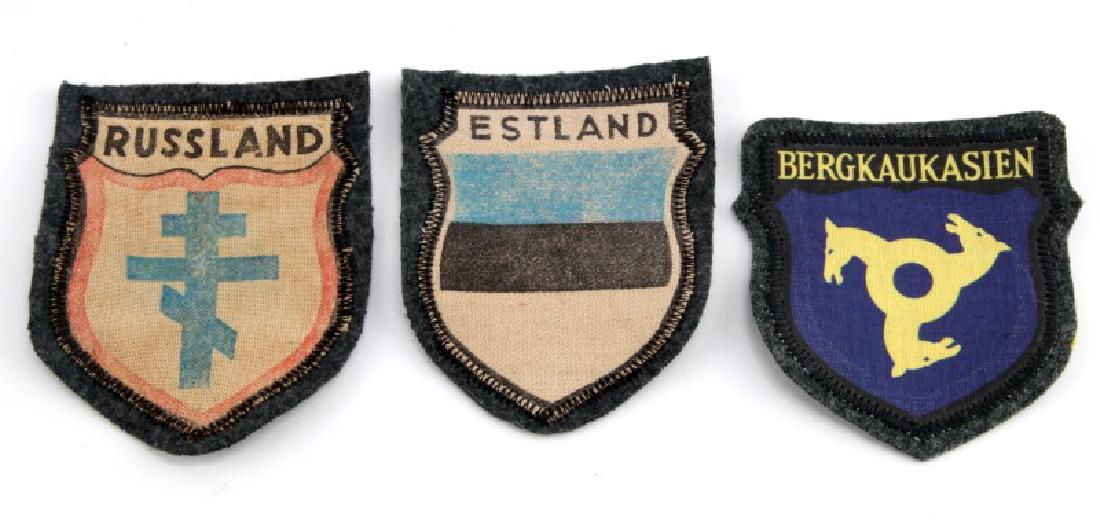 LOT OF 3 - VOLUNTEER PATCHES GERMAN WWII RUSSIA: Group of three patches of volunteers fighting with German WWII troops (Russia, Estonia, Mountain Cossacks). Badges vary in condition - "Russland" (3 1/2"x2 3/4") and "Estland" (3 1/2x2 3/4") appear a 