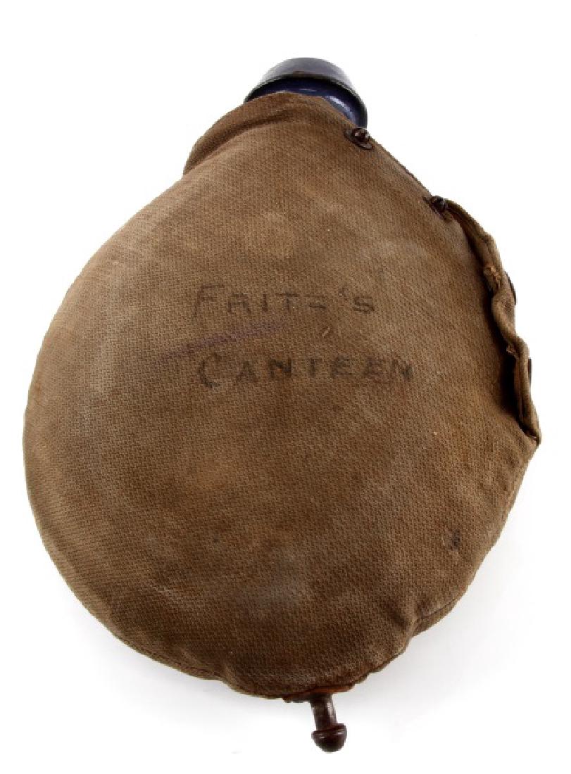 WWII GERMAN THIRD REICH FLASK CANTEEN WITH NAME: WWII German flask canteen with name. Has all original buttons. No hand strap or cup. In good condition. Light wear is present. Has the words "FRITZ'S CANTEEN" marked into the side.