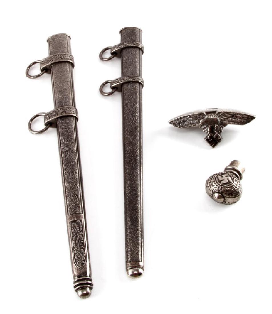 WWII GERMAN LUFTWAFFE DAGGER PARTS SCABBARDS ETC: Group of four (4) parts for the Luftwaffe 2nd model dagger. Includes 2 scabbards (11"), crossguard, and top. Very good condition. Unauthenticated. Sold "as is".