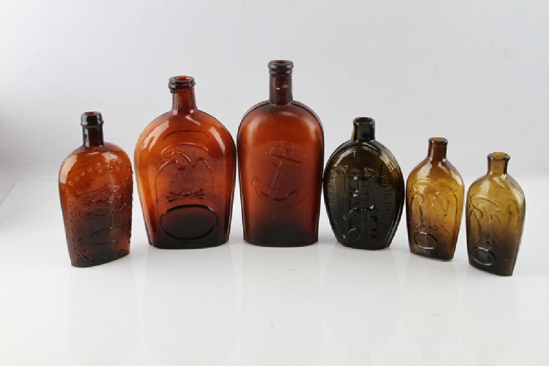 LOT 6 ANTIQUE BACK BAR BOTTLES ANCHOR RAILROAD ETC: Lot of six (6) 19th Century glass flasks/bottles. Includes: "Brown Anchor", "Brown Pittsburgh Eagle" - small crack to front, "Success to the Railroad" olive green/brown historical flask, and two (2) "