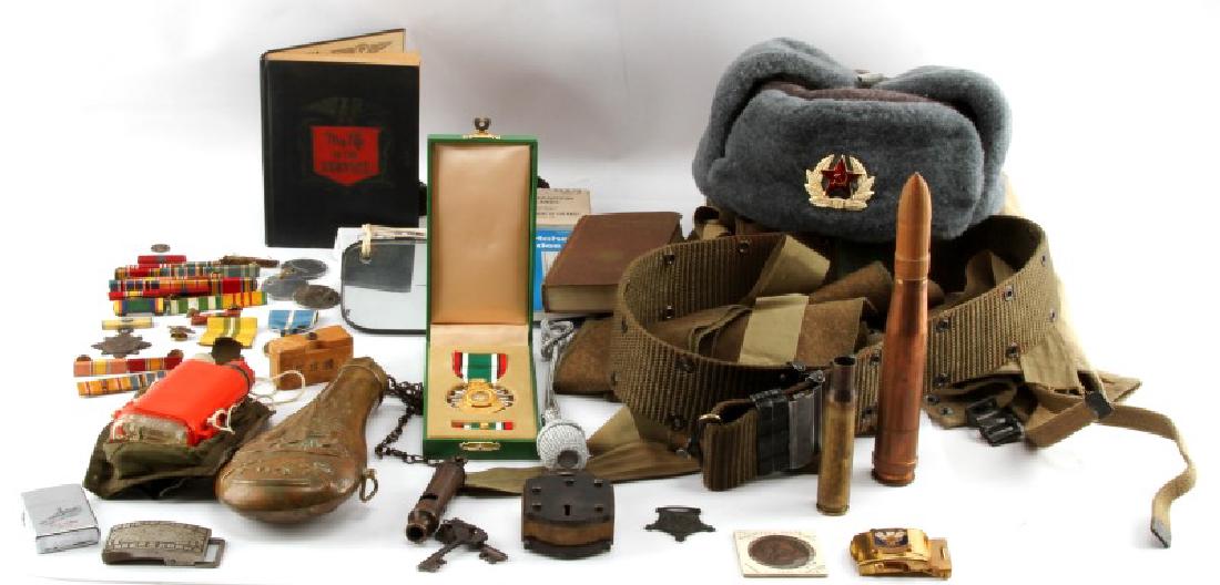 MULTI CONFLICT MILITARY COLLECTIBLE LOT BIG VARIED: Includes in part powder flask, missing measure, dummy wood round in cardboard tube, Vietnam era pilot distress light, WWII t-30 throat mic, Desert Storm boxed Saudi medal, signal mirror, Texas Cavalry