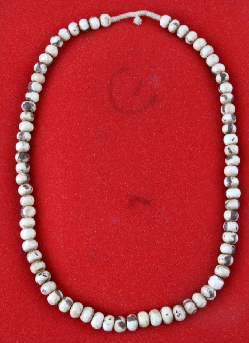 VINTAGE STRAND SHELL BEADS SPIRO MOUNDS OKLAHOMA: 16 1/2" strand (oval length) of large shell beads from the Spiro Mounds, La Flora, Oklahoma. Nice condition and displays nice in riker mount case.