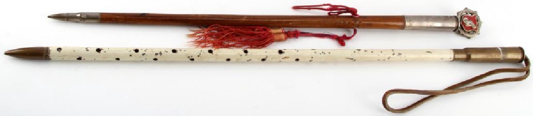 SET OF 2 US ARMY TRANSPORT SWAGGER STICKS: Set of two (2) U.S. Army transport/presentation swagger sticks: 1) one 23 1/4" metal stick with hole design throughout and leather strap at end (some paint chipping present), and 2) one 20 1/2" wooden