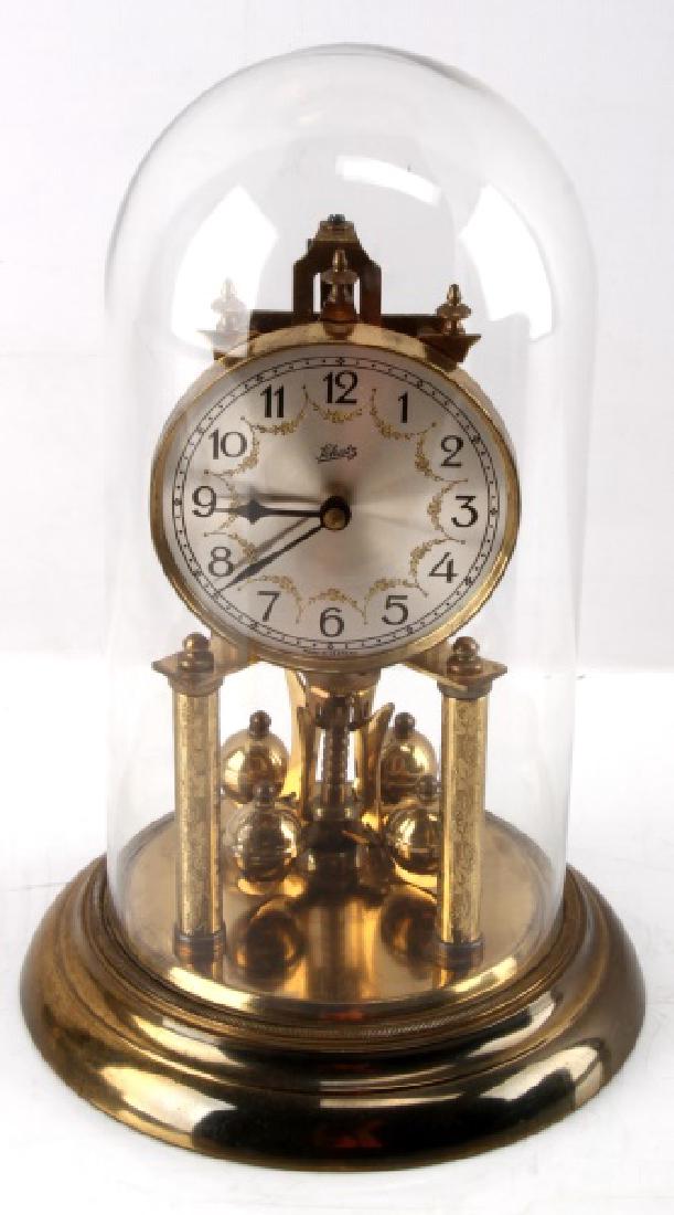 GLASS SCHATZ MANTLE CLOCK MADE IN GERMANY: Measures approximately 12" tall and has a diameter at the base of 25". Not tested. In excellent condition and comes with key. Please acquire third party shipping estimate prior to bidding.