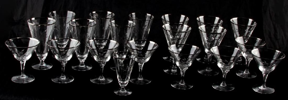 VINTAGE FOSTORIA ETCHED GLASSWARE 20 PC SILVER RIM: Vintage Fostoria glassware, 20 pieces. Features silver rim and crossed stems with leaves etched into front. Includes: 6 water goblets (6.5 inches tall), 5 wine glasses (6 3/8 inches), 8 martini or cha