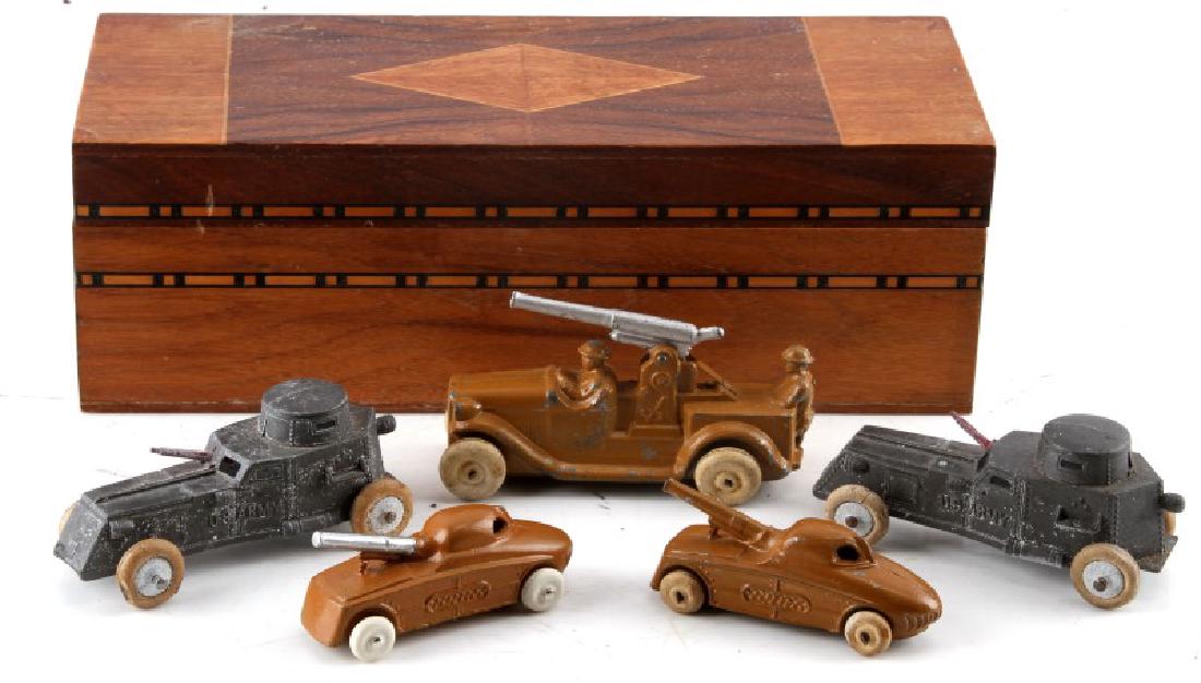 LOT OF 5 ANTIQUE CAST IRON US ARMY TOY VEHICLES: Lot of five (5) U.S. Army armored military vehicles range from approx. 3"-4". Paint wear and pitting. Wheels on a few of the vehicles are badly worn. Comes in generic wooden box (10 1/2" x 3 1/2" x 4"