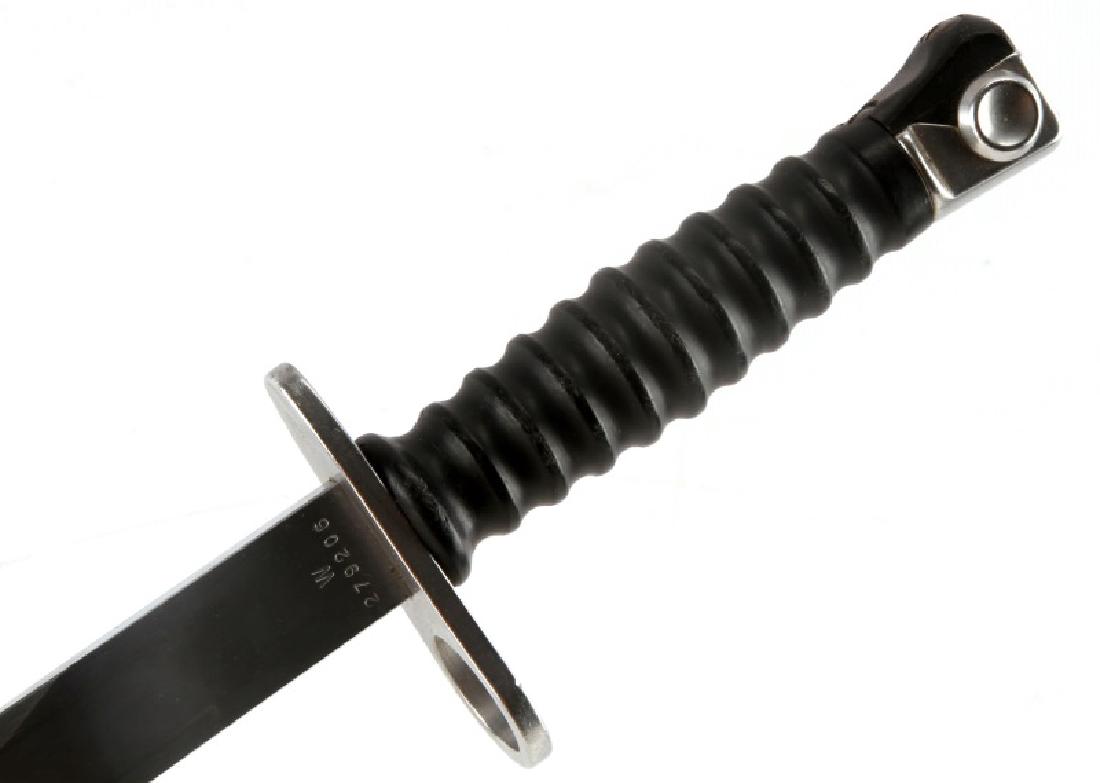 STG 57 SWISS BAYONET WTIH OLIVE VINYL FROG: STG 57 bayonet. Has a olive drab color vinyl frog. Sheath is in very good condition with light scratching. Blade is excellent. 14.25 inches in overall length with a 9.25 inch double edge blade.