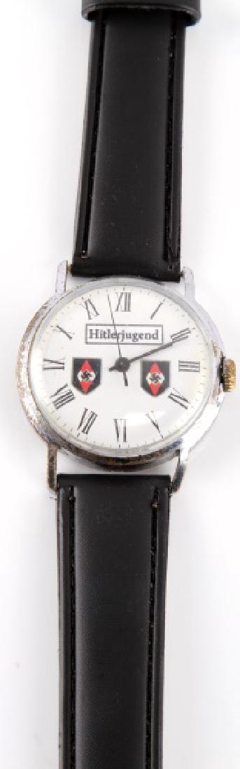VINTAGE GERMAN HITLER YOUTH WATCH HITLER JUGEND: Vintage German "Hitler Youth" watch. Leather watch band appears to be brand new (replaced?) and is missing part of clasp. Watch face is approx. 1 1/2" and has two Hitler Youth diamonds. Unauthenticate